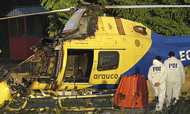 Chilean investigative police inspect a helicopter burned at the Arauco forestry company in Caranilahue, Temuco, on Wednesday.
