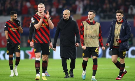 Pep Guardiola walks on the pitch with his Manchester City players after they squandered a lead to draw against RB Leipzig in the Champions League.