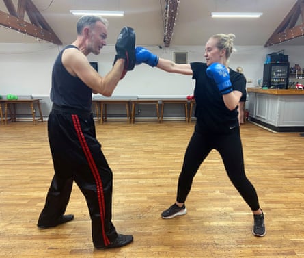 Lauren Potts and her instructor Alastair practising kickboxing moves during a training session