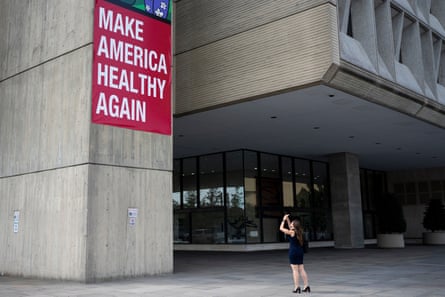 a person photographing a sign