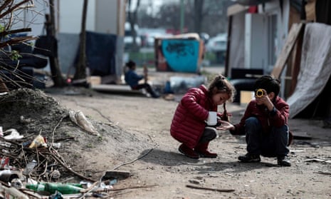 Children play in the camp of a Roma community that was attacked during the night of 25 March in Bobigny, near Paris.
