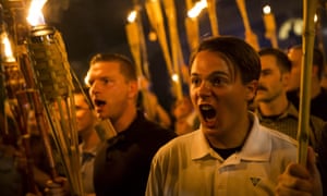 Unite the Right demonstrators carrying torches encircle and chant at counter-protestors at the base of a statue of Thomas Jefferson on the University of Virginia campus.