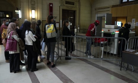 People wait in front of the entrance of the court room where Kunti Kamara was on trial in Paris.