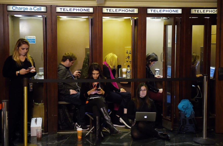 Journalists file information inside phone booths at the public impeachment hearings on 19 November 2019 on Capitol Hill in Washington DC.