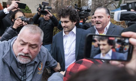 Cryptocurrency entrepreneur Sam Bankman-Fried is led out of a US federal courthouse after being released on bail following an arraignment in New York on 22 December.