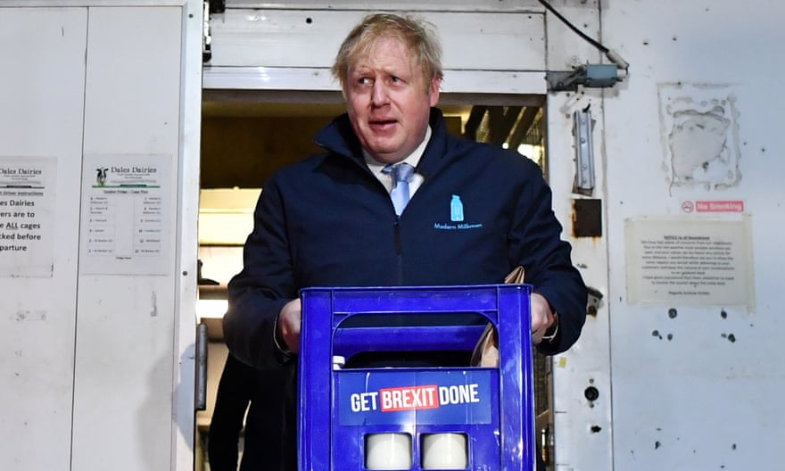 Boris Johnson carrying a crate of milk in Guiseley, Leeds the morning before the general election.