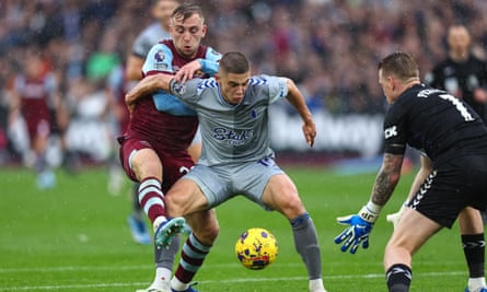 Everton’s Vitalii Mykolenko holds off West Ham’s Jarrod Bowen, with Jordan Pickford at the ready, during a rare moment of jeopardy in the visitors’ penalty box.