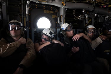 Sailors aboard an MV-22 Osprey aircraft travel to the USS George Washington. The Iranian government has repeatedly condemned US military actions in the strait of Hormuz.