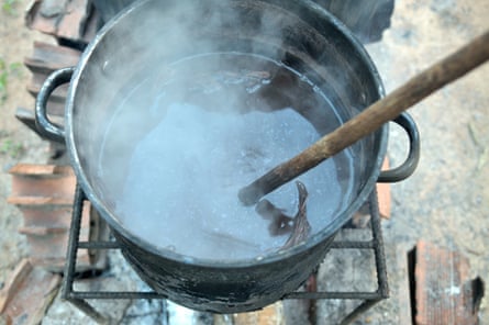 Ayahuasca being brewed over a wood fire in the village of San Francisco, near Pucallpa, Peru.