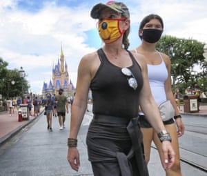Guests wear masks as required to attend the official reopening day of the Magic Kingdom at Walt Disney World in Lake Buena Vista, Florida, on Saturday, 11 July 2020.
