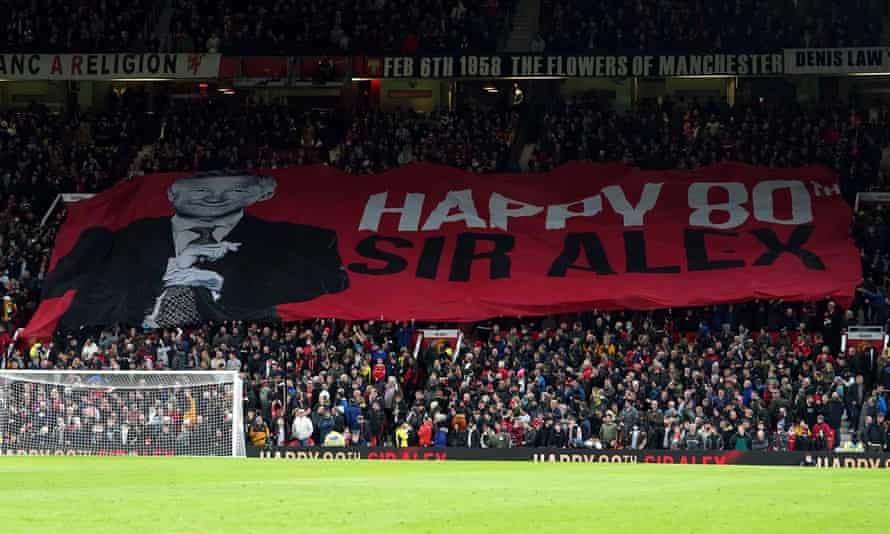 A banner celebrating Sir Alex Ferguson's 80th birthday is unfolded in Stretford End