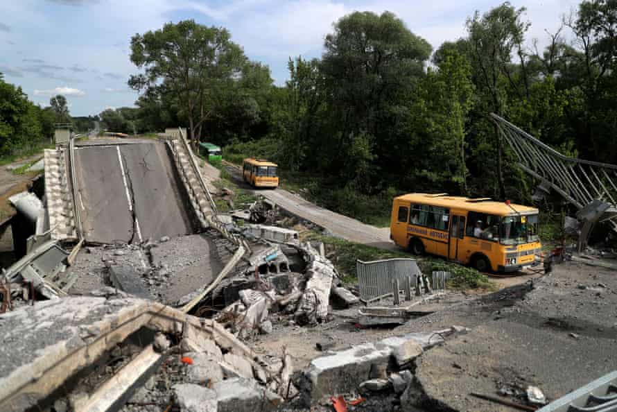 The buses have to pick their way along damaged roads.
