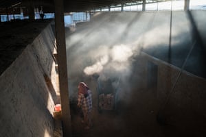 Putrea cleans ash from a brick kiln