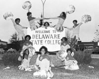 Cheerleaders in front of Delaware State College sign