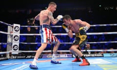 Anthony Crolla, right, and Ricky Burns exchange blows during the lightweight contest at Manchester Arena.