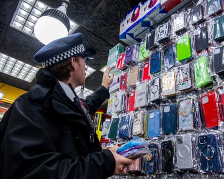 Police check phone cases on the wall