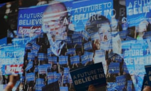 A video screen shows US Democratic presidential candidate Bernie Sanders and his wife Jane at his Super Tuesday rally in Burlington, Vermont.