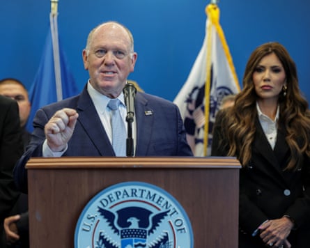 Tom Holman at podium in suit