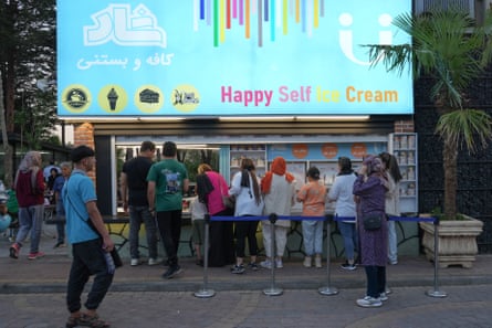 People queue outside an ice-cream parlour in Tehran.