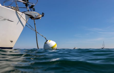 A boat tied to an eco-mooring at Studland Bay.