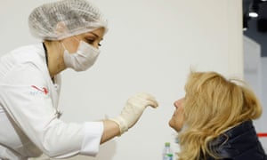 A woman undergoes a free coronavirus disease (COVID-19) rapid antigen test at a testing centre.