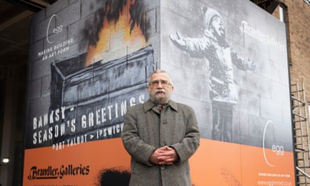 Essex art dealer John Brandler with the Banksy artwork he bought shortly after it appeared