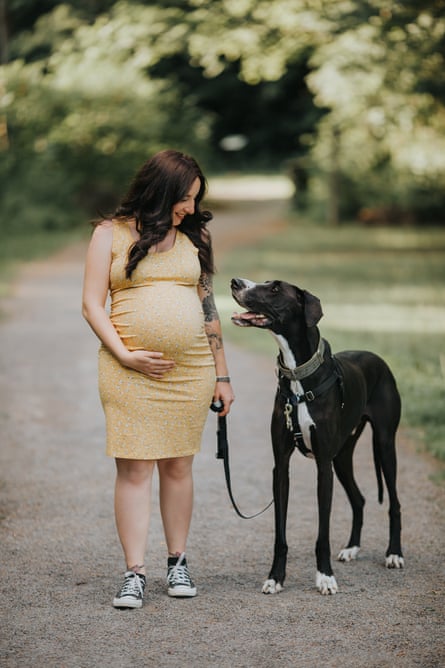 a woman smiles with her dog