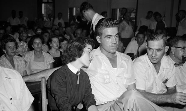 In a September 1955 photo, Carolyn Bryant rests her head on her husband Roy Bryant's shoulder after she testified in the Emmett Till murder case in Sumner, Mississippi.