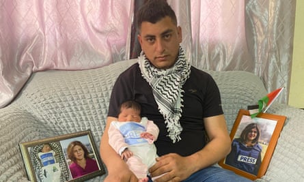 Jamal Imran holds baby Shireen, born on the same day Abu Aqleh was killed and named after the journalist.