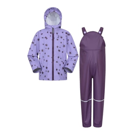 Raindrop Waterproof Jacket and Trousers Set Mountain Warehouse. The trousers are in a dungaree style in dark purple. The hooded jacket is light purple with dark purple stars.