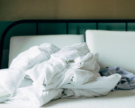 Clean white bedding in a room, on an unmade bed