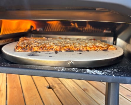 Slice of cheese and tomato pizza cooking in the ProCook Outdoor Pizza Oven.