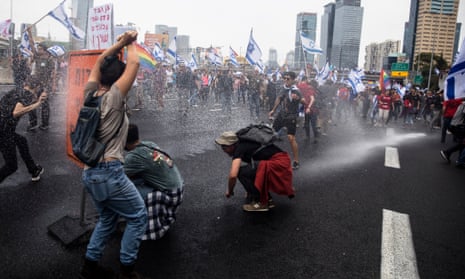 Israeli police in Tel Aviv use a water cannon to disperse protesters against judicial changes.