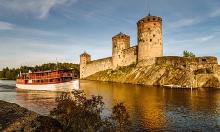A lake cruise ship passes Savonlinna’s fortress, in Finland.