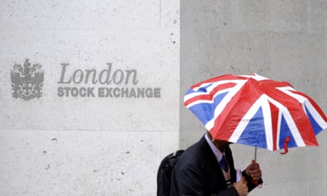 Man using a Union Flag umbrella next to the London Stock Exchange sign