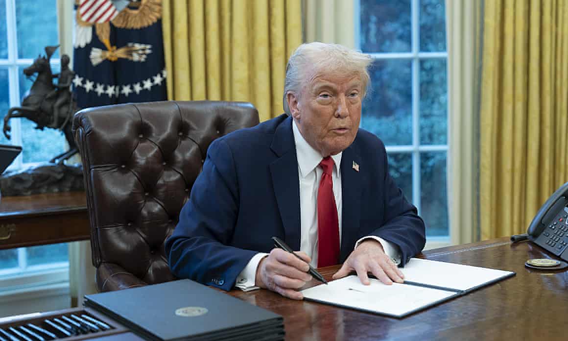 Donald Trump signing executive orders in the Oval Office