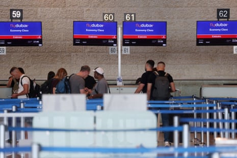 About a dozen people at FlyDubai desks at the airport.