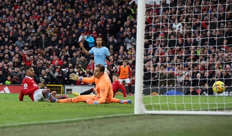 Manchester United’s Marcus Rashford scores past Manchester City’s Ederson