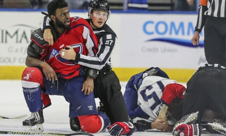 Jordan Subban, left, is held by an official while Jacob Panetta (15) is face-down on the ice engaged with another player during Saturday’s game