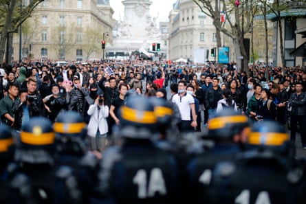 People face riot police as they take part in a demonstration in Paris after Liu Shaoyo was killed by police in 2017.