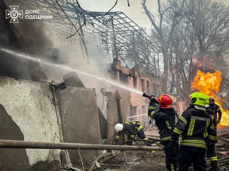 A state emergency service of Ukraine handout photo shows firefighters at the scene of the missile strike.