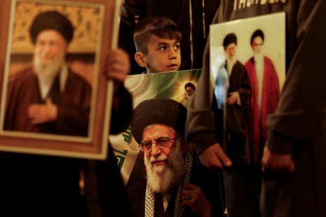 A boy carries a portrait of Iranian Supreme Leader Ayatollah Ali Khamenei during a symbolic funeral procession, following his death in Israeli and US airstrikes, amid the US-Israeli conflict with Iran, in Najaf, Iraq 3 March 2026.