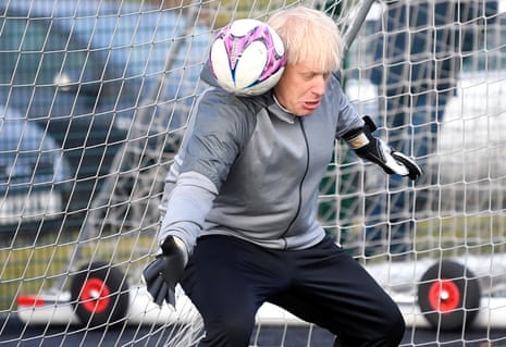 Boris Johnson gets into a tangle when trying to save a shot before a girls’ match in December 2019.