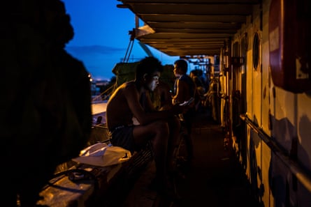 A fisherman uses his smartphone on the boat on in Kaohsiung, Taiwan.