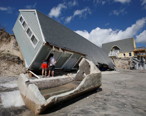 Local residents look inside a collapsed coastal house in the wake of Hurricane Irma in Vilano Beach, Florida.