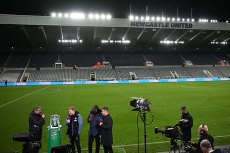 Newcastle United's English head coach Eddie Howe (second left) gives an interview to Sky Sports after the English League Cup quarter final football match between Newcastle United and Leicester City at St James' Park.