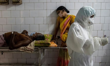 A woman leans against a stretcher holding her husband in the corridor of the emergency ward of a hospital in Bhagalpur, in the eastern state of Bihar.