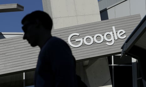 a man walks past a building on the Google campus in Mountain View, California