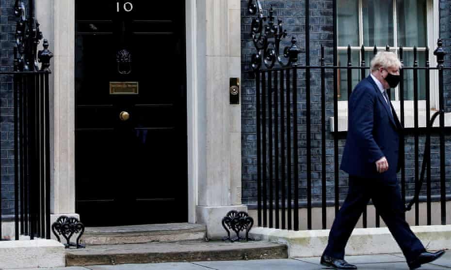Boris Johnson walks outside 10 Downing Street in London