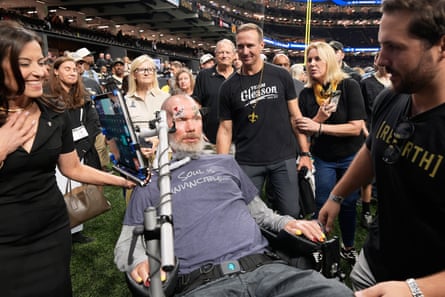Former New Orleans Saints quarterback Drew Brees, middle right, approaches former player Steve Gleason